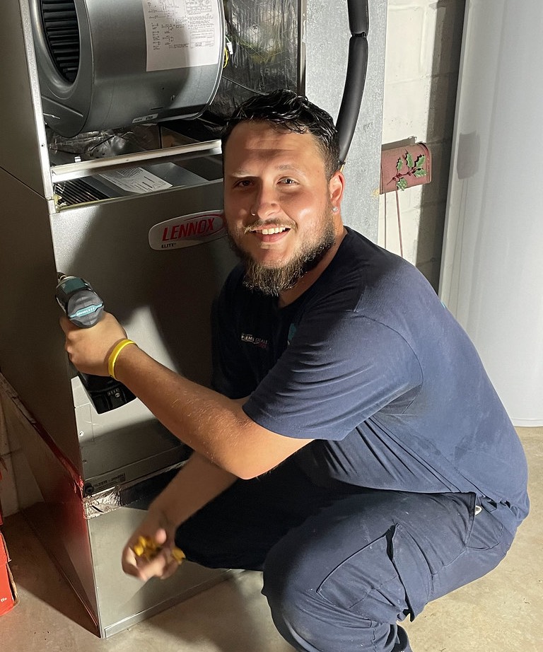 Technician servicing an indoor air handler unit